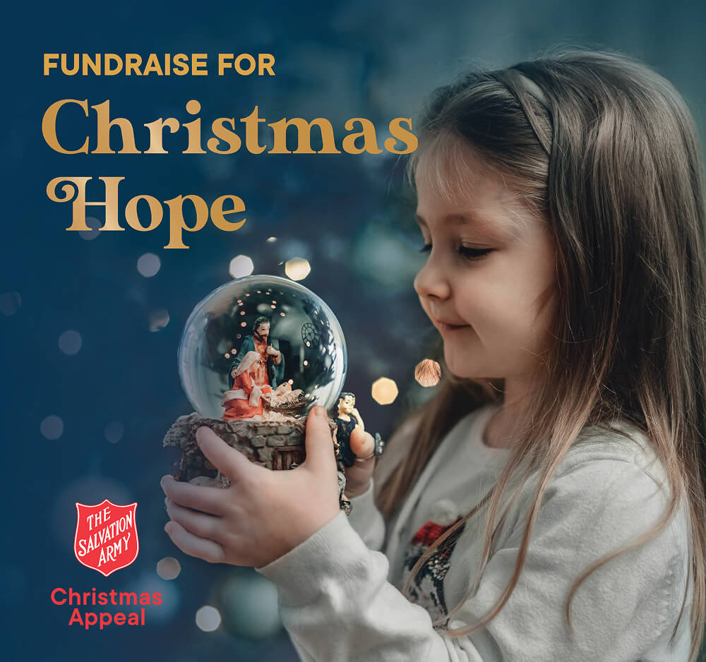 Christmas hope, a young girl holding a Christmas snowglobe