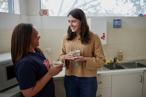 A Salvos personnel having a cuppa with a lady