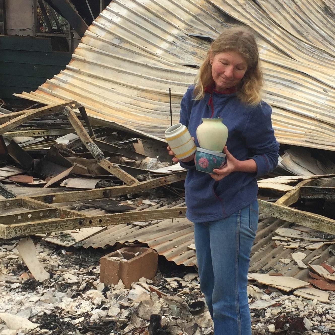 Girl standing near a demolished building