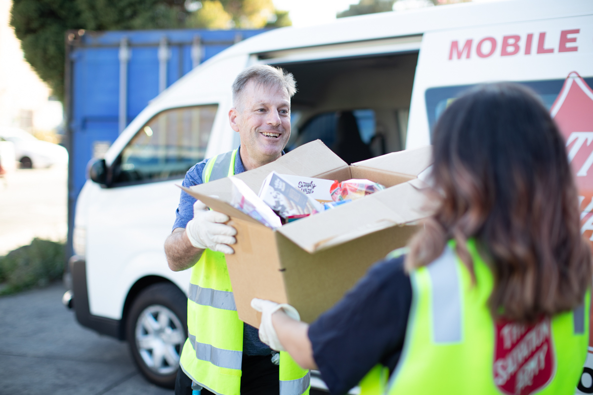 Salvos team member distributing supplies 