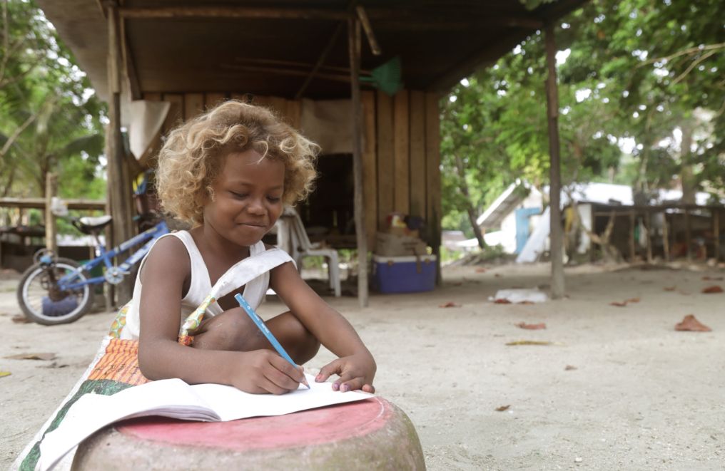 A girl writing outdoors