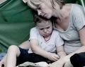 Mother with her child living in a tent