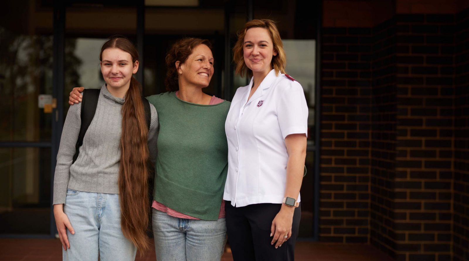 A mother and daughter celebrate Christmas with a Salvation Army officer