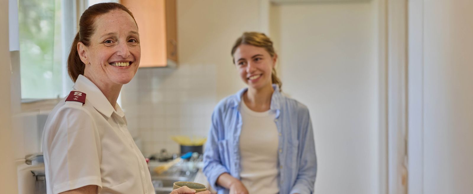 Ava smiling with a Salvos personnel in her home for the night