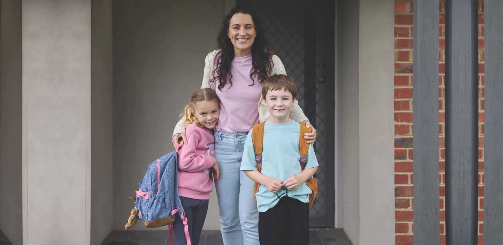 Sizu with her two children smiling as they have a home for the night