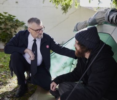 Salvos officer assisting homelessness person