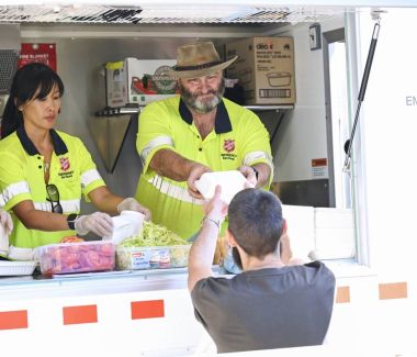 Emergency service volunteers providing food to people who need it. 