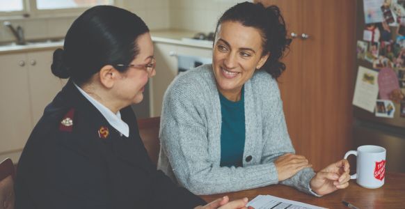 Suzi smiling and speaking with a Salvos personnel