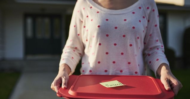 Woman holding container of food