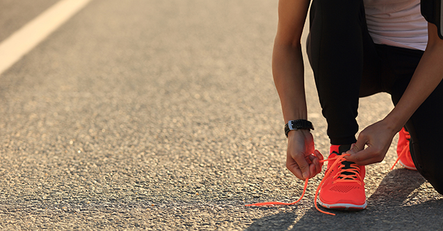 Runner tying up shoe laces