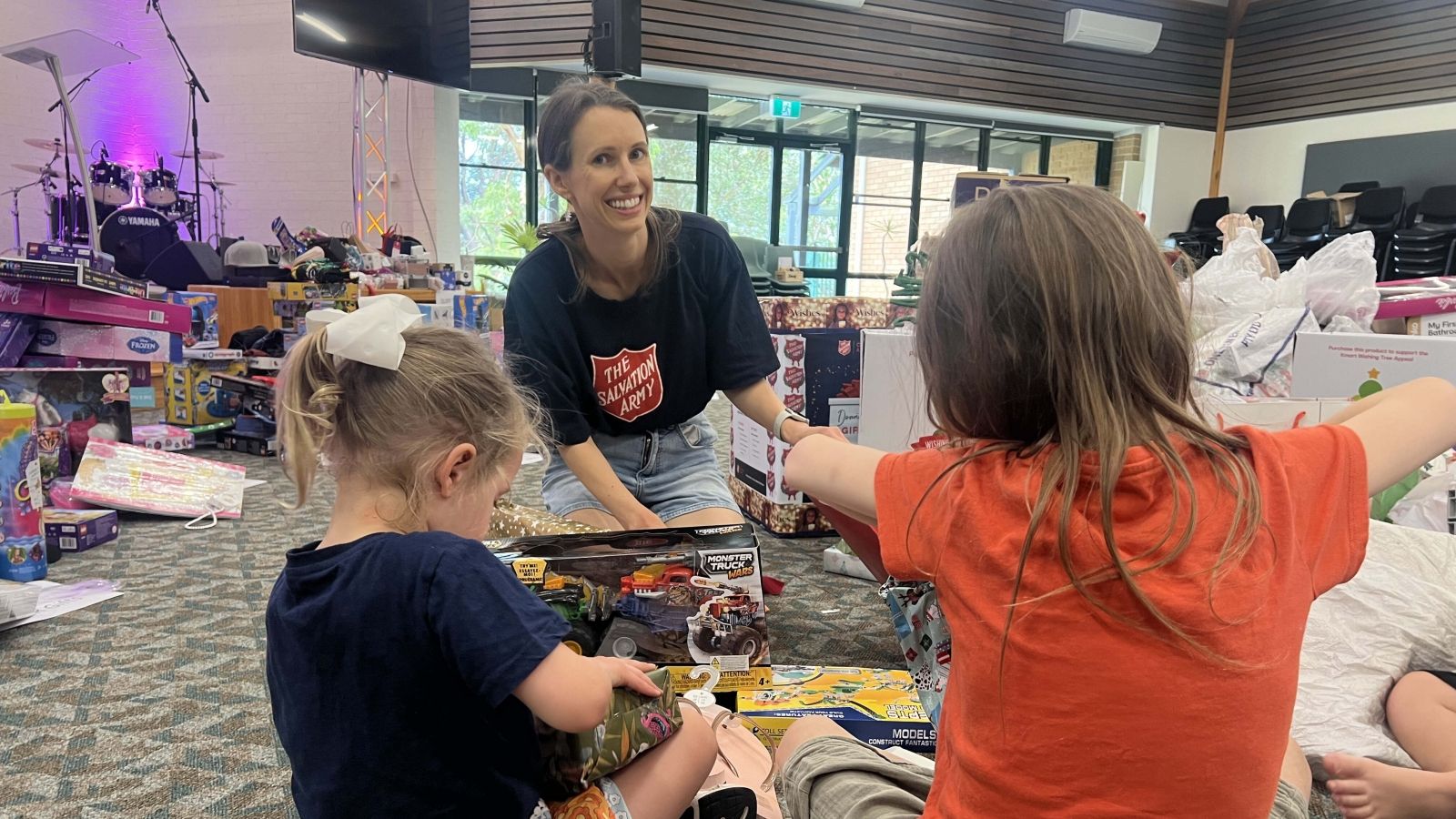 Julia packs gifts with her children volunteering