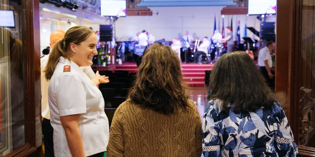 Salvos officer explaining about Christmas to kids