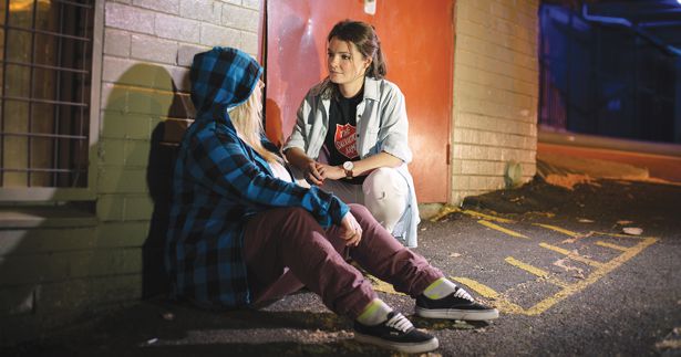 Young Salvos volunteer helping rough sleeper