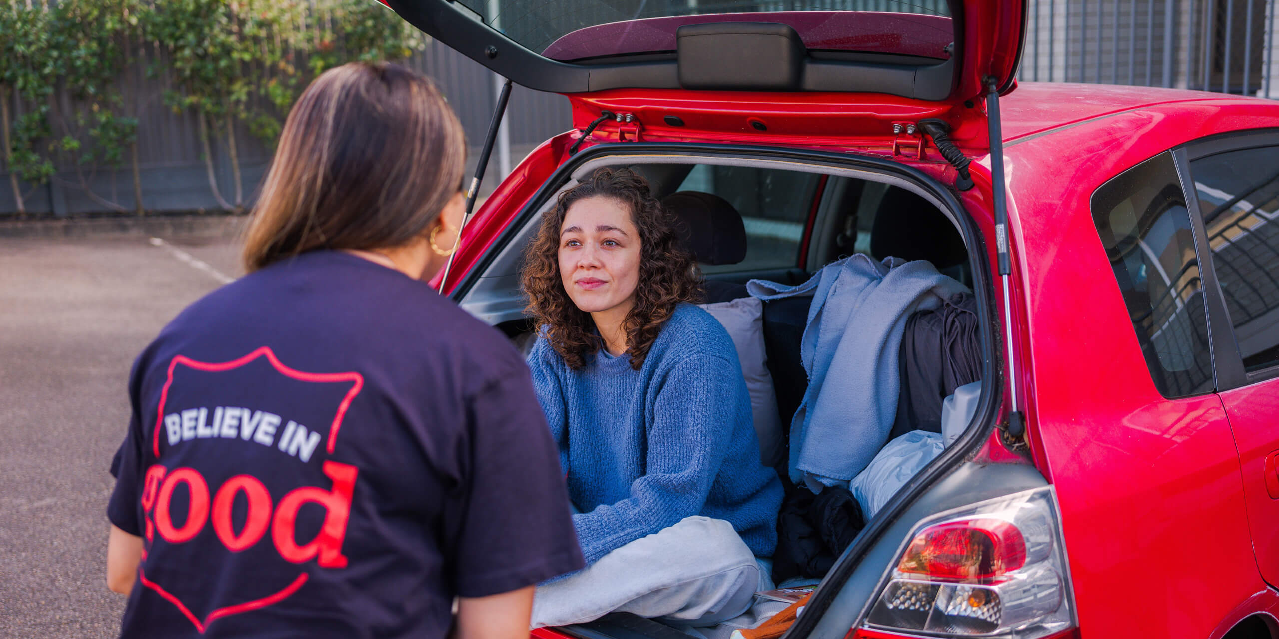 A Salvos personnel helping a woman living in a car.